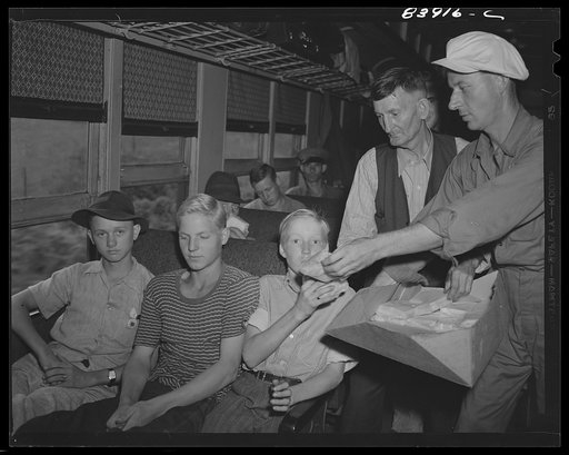 Bryant Friend helped distribute free sandwiches to the migratory workers en route to help with the harvest in upper New York state