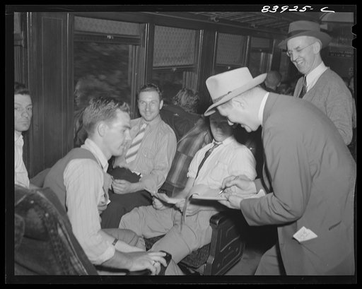 Untitled photo, possibly related to: Richwood, West Virginia. Men recruited for harvest work in New York state having their tickets checked before boarding train in Richwood