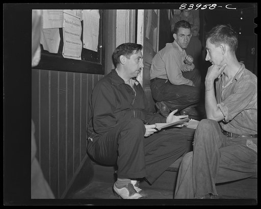 Summersville, West Virginia. FSA (Farm Security Administration) representative explaining the FSA contract for migratory workers on the steps of the courthouse