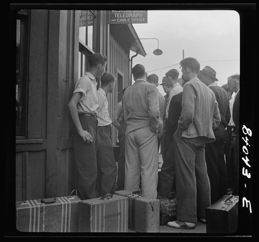 Richwood, West Virginia. Boys waiting at the station to board train for upper New York state to work in the harvest