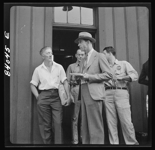 Richwood, West Virginia. United States employment agent checking off boys going to upper New York state to help in the harvest