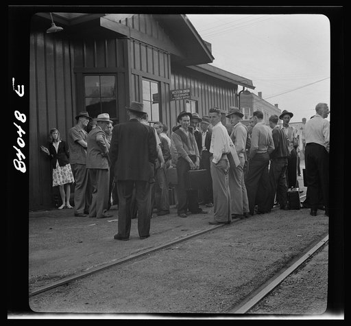 Richwood, West Virginia. Boys and girls waiting to board a train for upper New York state to help in the harvest