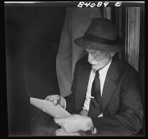 Untitled photo, possibly related to: Summersville, West Virginia. Oldsters examining the FSA (Farm Security Administration) contract for migratory labor