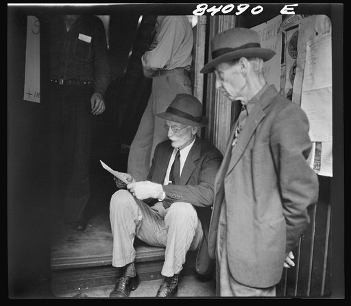Summersville, West Virginia. Oldsters examining the FSA (Farm Security Administration) contract for migratory labor