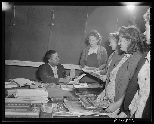 Batavia, New York. Elba FSA (Farm Security Administration) farm labor camp. Recreational director signing out books from the camp library to newly-arrived high school girls from Richwood, West Virginia.