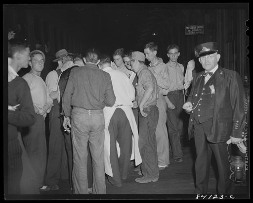 Farm workers from West Virginia buying food at a train stop, en route to Batavia, New York. They are going to upper New York state to help bring in the crops