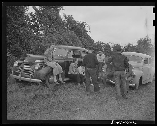 Batavia, New York. Elba FSA (Farm Security Administration) farm labor camp. Group of boys and girls from West Virginia. negotiating for work with two farmers who have large tomato fields. They will not be separated, so the farmer must hire them as a group