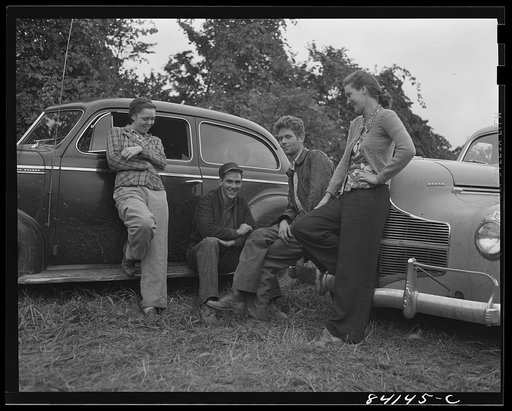 Batavia, New York. Elba FSA (Farm Security Administration) farm labor camp. Group of boys and girls from West Virginia negotiating for work with two farmers who have large tomato fields. They will not be separated, so the farmer must hire them as a group
