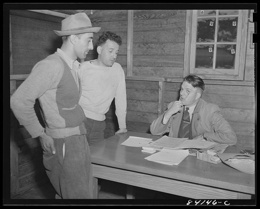 Batavia, New York. Elba FSA (Farm Security Administration) farm labor camp. Two farmers bargaining for labor with the United States Employment Service