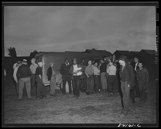 Batavia, New York. Elba FSA (Farm Security Administration) farm labor camp. Traveling grocer who did a rushing business selling bread and cold meats to the migrants