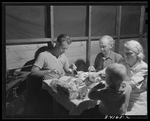 Batavia, New York. Elba FSA (Farm Security Administration) farm labor camp. The Friends at dinner