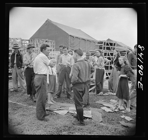 Batavia, New York. Elba FSA (Farm Security Administration) farm labor camp. Man on the left is a former relief client who was transported from New York City to work in the crops. Man to right is from West Virginia