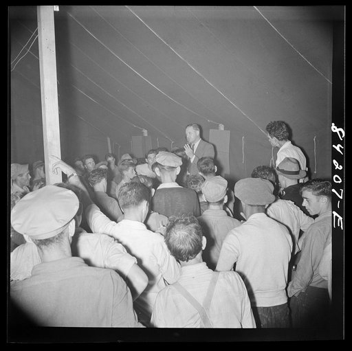 Untitled photo, possibly related to: Batavia, New York. Elba FSA (Farm Security Administration) farm labor camp. Ray Mork, FSA official, addressing West Virginia migrants on the night of their arrival