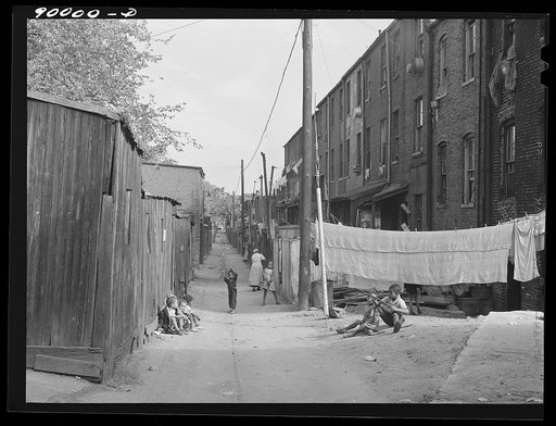 Children playing in De Frees Street, N.E. near the Capitol building. One basement room rents for nine dollars a month; two rooms upstairs for sixteen dollars; one bath and cold water in the hall for entire building