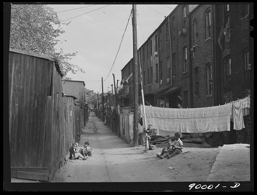 Children playing in De Frees Alley, N.E. near the Capitol building. One basement room rents for nine dollars a month; two rooms upstairs for sixteen dollars; one bath and cold water in the hall for entire building