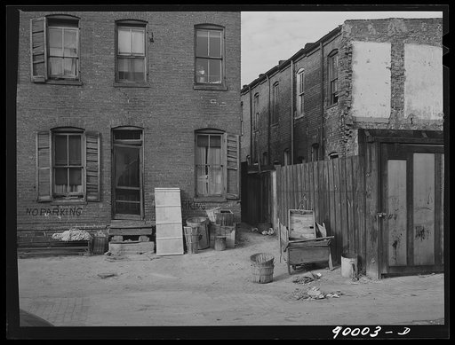 Negro slums. Alexander Court between K and L Streets N.W. A woman and her two children lived in four small rooms eight and one half years and pay twelve fifty a month for rent. Water and privy in the yard. Rents in nearby houses have gone up but not here