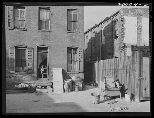 Negro slums. Alexander Court between K and L Streets N.W. A woman and her two children lived in four small rooms eight and one half years and pay twelve fifty a month for rent. Water and privy in the yard. Rents in nearby houses have gone up but not here