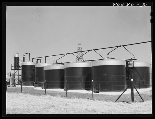Oil well derricks and tanks in field near Wichita, Kansas