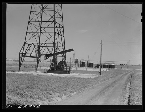 Oil well derricks and tanks in field near Wichita, Kansas