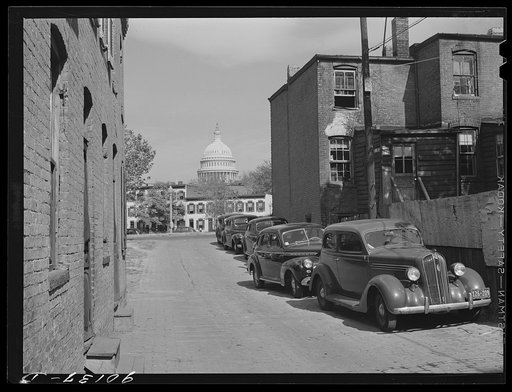 Temple Court off D Street and Delaware Avenue, S.W. Washington, D.C. Negro slum area with Capitol in background