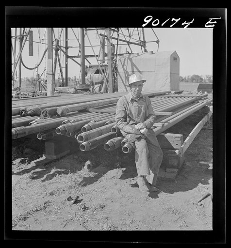 Floyd Swick, welder from Newton, Kansas worked in oil fields about ten years; cutting tool joints off a drill pipe in Goodrich field of Continental oil company. Valley Center oil field near Wichita, Kansas