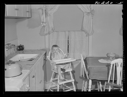 Mary K. Ratcliff, daughter of defense worker, in the kitchen of their home. Sunset Village, FSA (Farm Security Administration) project. Radford, Virginia