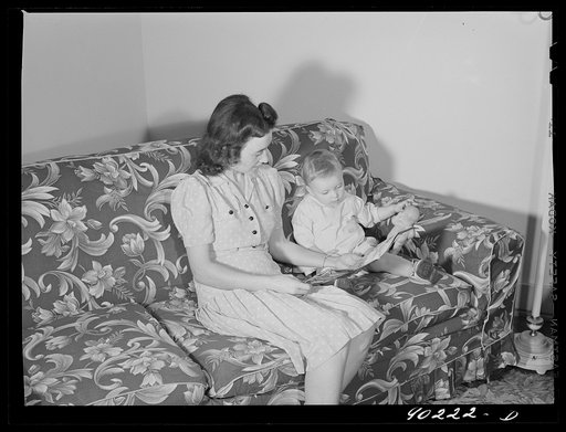 Mrs. Therman N. Ratcliff, defense worker's wife with their daughter, Mary K. Ratcliff, in their living room. Sunset Village, FSA (Farm Security Administration) project, Radford, Virginia