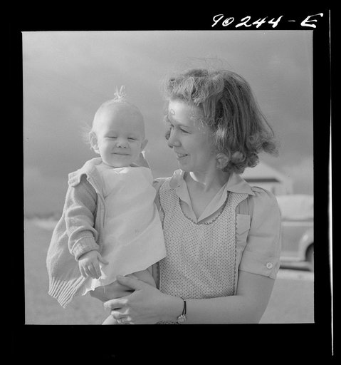 Mrs. B.M. Henderson, wife of defense worker, and daughter, who live in Sunset Village. FSA (Farm Security Administration) project. Radford, Virginia
