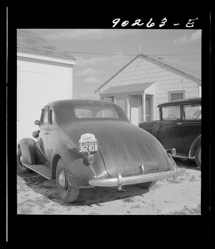 Untitled photo, possibly related to: "Help Radford Blow The Hell Out Of Hitler" sign on the back of a defense worker's car in front of his home in Sunset Village, FSA (Farm Security Administration) project. Radford, Virginia