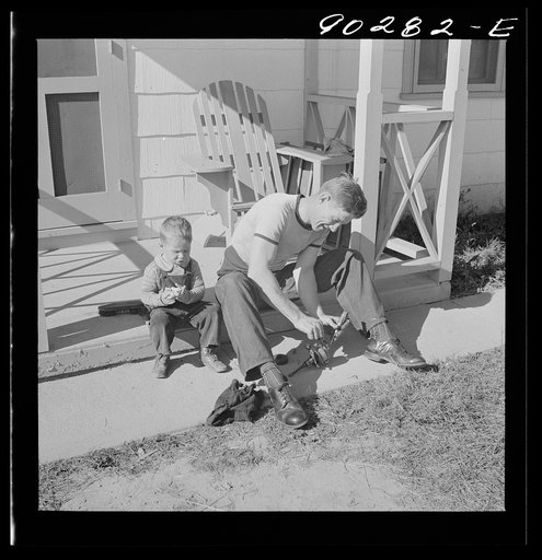 Radford, Virginia. Sunset Village, FSA housing project. Fred B. Williams from Savannah, Georgia, and his son "Buddy" cleaning the car distributer on the porch of his home. 803 9th Street