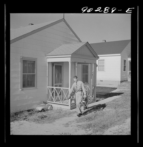 Untitled photo, possibly related to: Fred B. Williams from Savannah, Georgia, a safety engineer at the powder plant, leaving his home at 803 9th Street. Sunset Village, Radford, Virginia. FSA (Farm Security Administration) project for defense workers