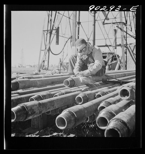 Floyd Swick, welder from Newton, Kansas worked in oil fields about ten years; cutting tool joints off a drill pipe in Goodrich field of Continental oil company. Valley Center oil field near Wichita, Kansas