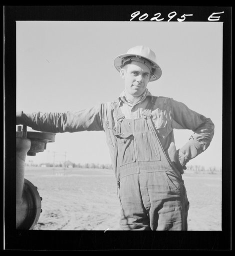Oil man by new well being drilled in Goodrich field of Continental oil company. Valley Center oil field near Wichita, Kansas