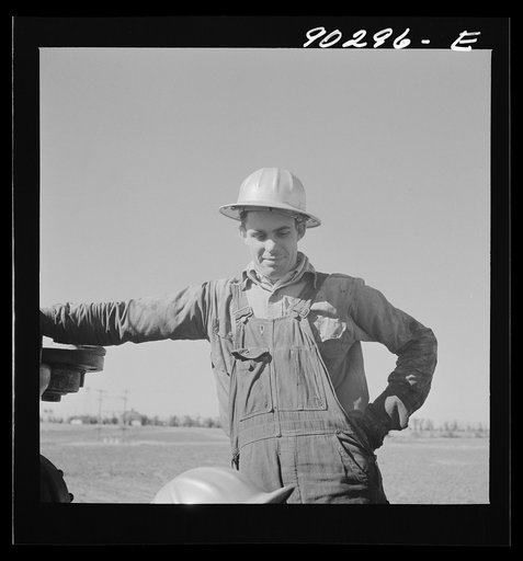 Oil man by new well being drilled in Goodrich field of Continental oil company. Valley Center oil field near Wichita, Kansas