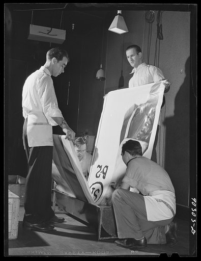 Washington, D.C. Preparing the defense bond sales photomural to be installed in the Grand Central terminal, New York, in the photographic laboratory of the FSA (Farm Security Administration). Reenacment of development of a print strip