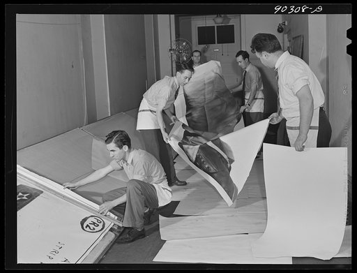 Washington, D.C. Preparing the defense bond sales photomural to be installed in the Grand Central terminal, New York, in the photographic laboratory of the FSA (Farm Security Administration). Drying print strips in the corridor