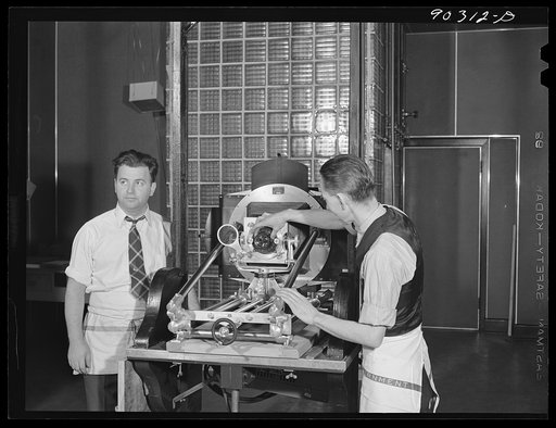 Washington, D.C. Preparing the defense bond sales photomural to be installed in the Grand Central terminal, New York, in the photographic laboratory of the FSA (Farm Security Administration). The enlarger used for making the print strips
