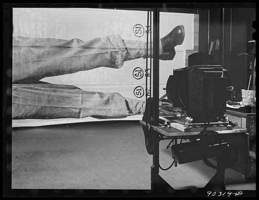 Untitled photo, possibly related to: Washington, D.C. Preparing the defense bond sales photomural to be installed in the Grand Central terminal, New York, in the photographic laboratory of the FSA (Farm Security Administration). The enlarger used for making the print strips