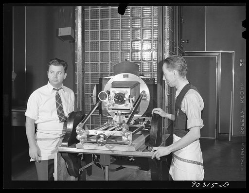 Untitled photo, possibly related to: Washington, D.C. Preparing the defense bond sales photomural to be installed in the Grand Central terminal, New York, in the photographic laboratory of the FSA (Farm Security Administration). The enlarger used for making the print strips