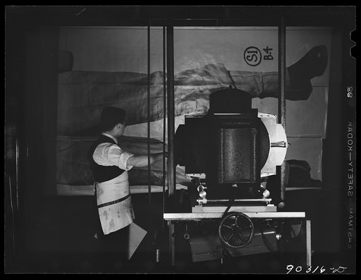 Untitled photo, possibly related to: Washington, D.C. Preparing the defense bond sales photomural to be installed in the Grand Central terminal, New York, in the photographic laboratory of the FSA (Farm Security Administration). Assembling print strips in the laboratory to check matching edges and t
