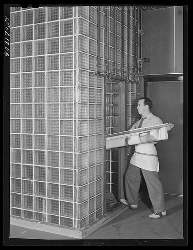 Untitled photo, possibly related to: Washington, D.C. Preparing the defense bond sales photomural to be installed in the Grand Central terminal, New York, in the photographic laboratory of the FSA (Farm Security Administration). Taking developed print strip into the washer