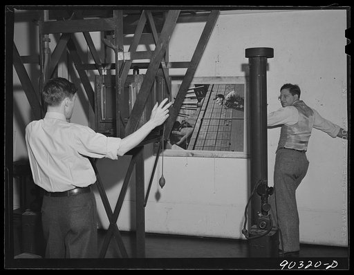 Washington, D.C. Preparing the defense bond sales photomural to be installed in the Grand Central terminal, New York, in the photographic laboratory of the FSA (Farm Security Administration). Copying the exact scale paste-up to produce the negative for the final enlargements; this work was done in t