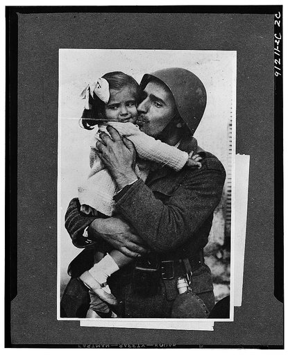 A Greek soldier holding his little daughter in his arms