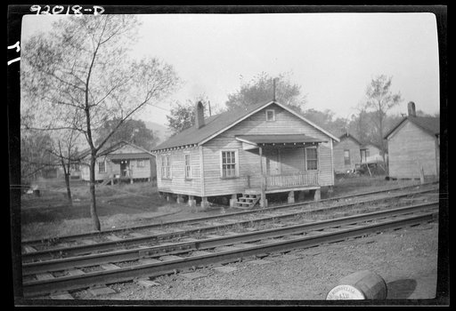 Eleanor, West Virginia. Four-room houses occupied by workers at the Plymouth mines, five miles east of the Red House Farms project, on highway number thirty-five. New York Central Railroad water is carried from a well across the railroad tracks