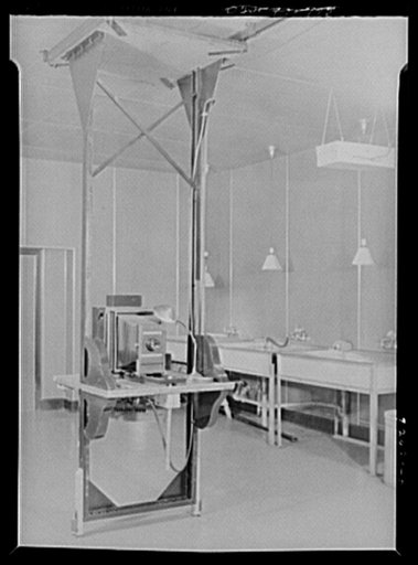 U.S. FSA (Farm Security Administration), later U.S. Office of War Information, photograph laboratory in the Auditor's Building. Washington, D.C. Combination stand for horizontal mural enlarger, shown without lamp house, and Leitz 35mm enlarger for extreme vertical projection. Photo murals as large a