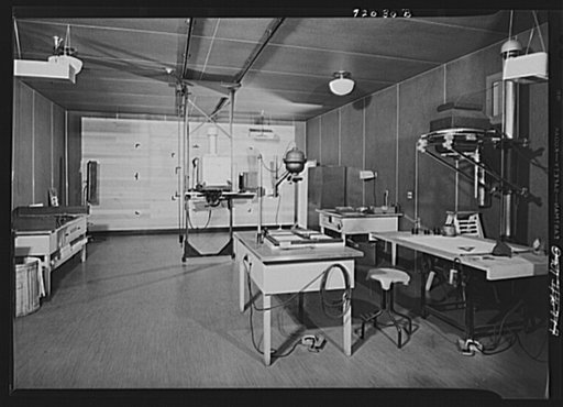 U.S. FSA (Farm Security Administration), later U.S. Office of War Information, photograph laboratory in the Auditor's Building. Washington, D.C. Enlarging room showing a Saltzman enlarger on the right, a Leitz 35mm enlarger (center), and a mural enlarger in the background