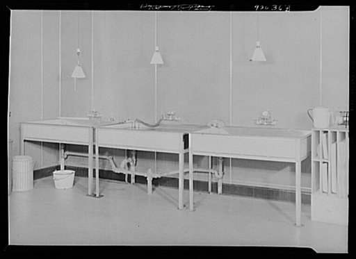 U.S. FSA (Farm Security Administration), later U.S. Office of War Information, photograph laboratory in the Auditor's Building. Washington, D.C. Developing trays and wash tanks in the mural printing room