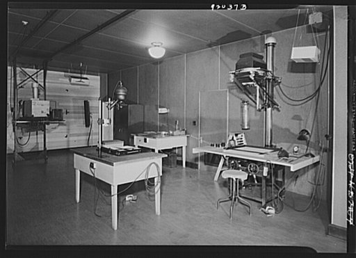 U.S. FSA (Farm Security Administration), later U.S. Office of War Information, photograph laboratory in the Auditor's Building. Washington, D.C. Mural printing room, showing from left to right, a mural enlarger, a Leitz, and a Saltzman enlarger