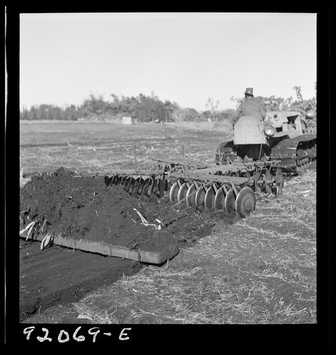 Untitled photo, possibly related to: Sugarcane fields. Tractor-driven disc plough and harrow is used on many large flat muck land farms. This farm is about 2000 acres. Near Lake Okeechobee and Clewiston, Florida