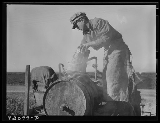 Untitled photo, possibly related to: Migrant day laborer from Carolina mixing spray to kill white flies and nourish bean plants through leaves. Near Belle Glade, Florida.